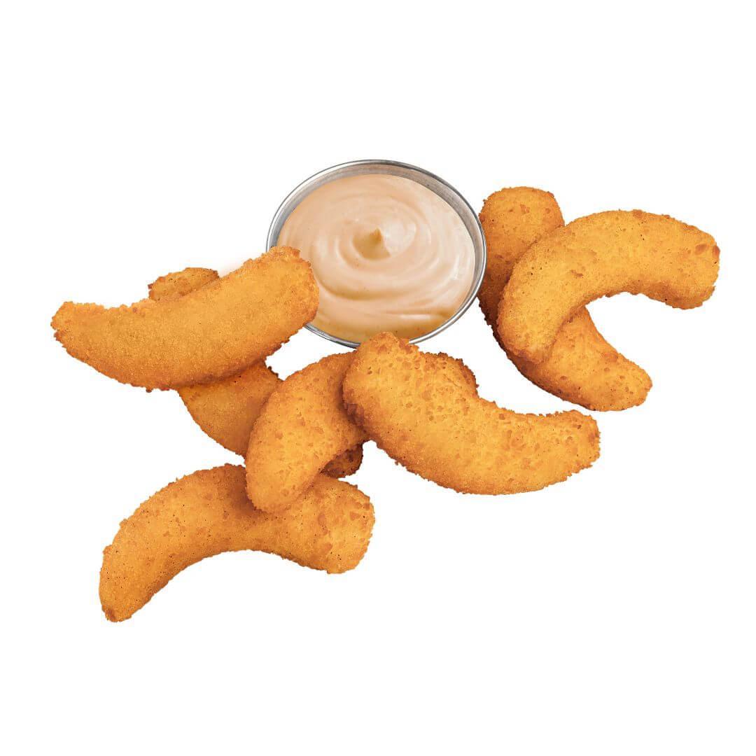Curved plant-based nuggets with creamy dipping sauce, iPlantBased UAE vegan snack.