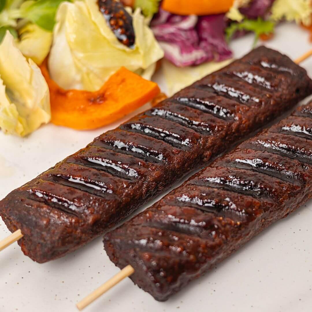 Grilled plant-based kebab skewers with fresh mixed vegetables from iPlantBased UAE