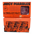 Two boxes of Juicy Marbles plant-based steaks on a white background