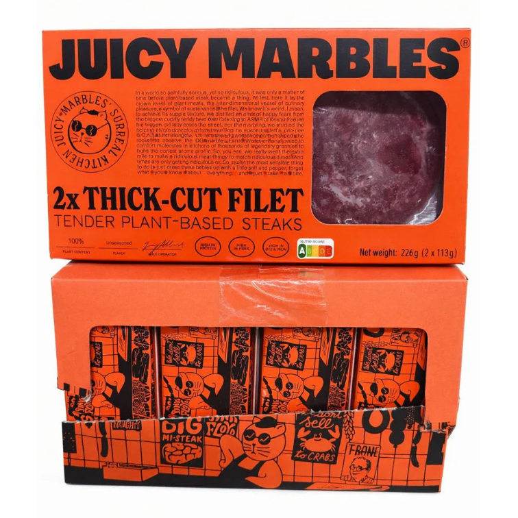 Two boxes of Juicy Marbles plant-based steaks on a white background