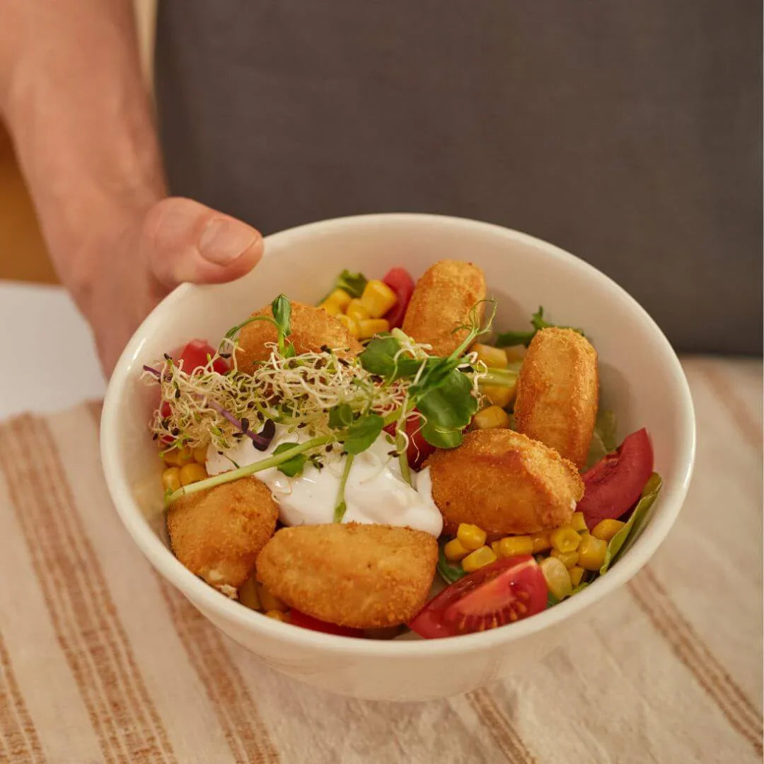 Plant-based nuggets salad bowl with corn, tomatoes, sprouts, and vegan sauce from iPlantBased UAE