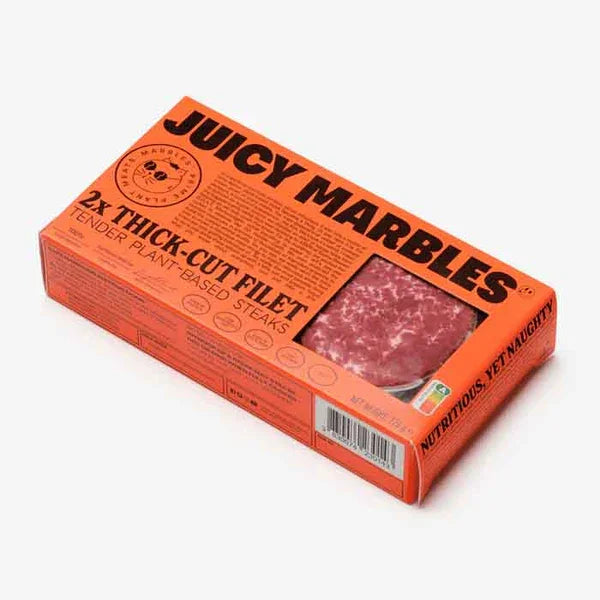 Orange packaging of 'Juicy Marbles' plant-based steaks on a white background