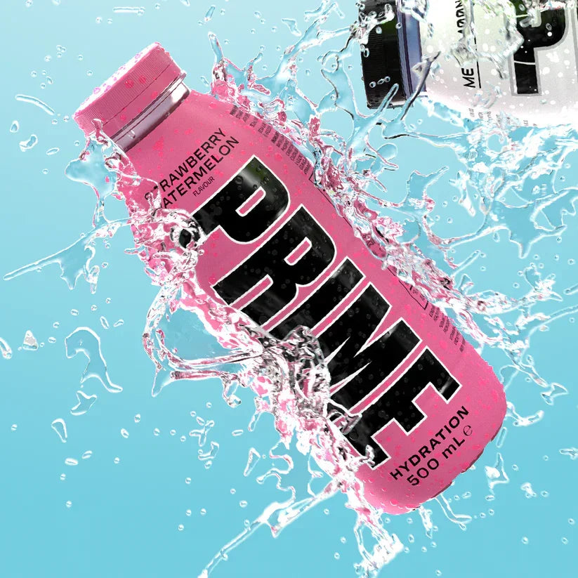 Pink strawberry watermelon Prime hydration drink bottle splashing in water