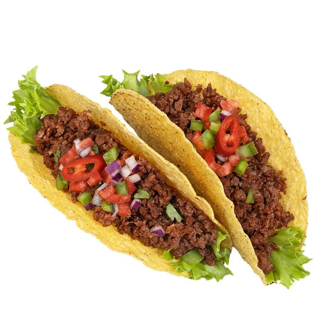 Two plant-based tacos with lettuce, vegan mince, chopped red onion, tomato, and bell pepper