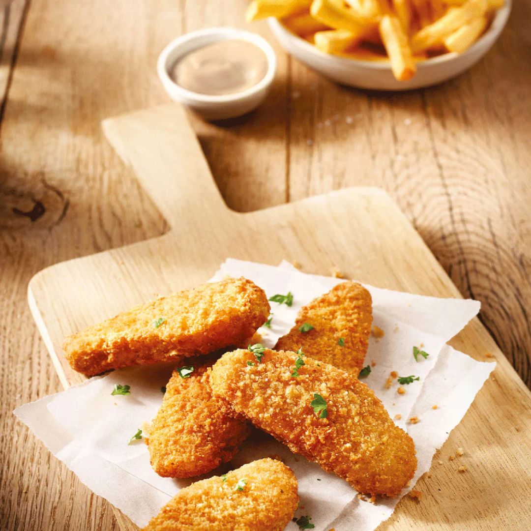Plant-based nuggets on a wooden board with fries and dipping sauce, iPlantBased UAE