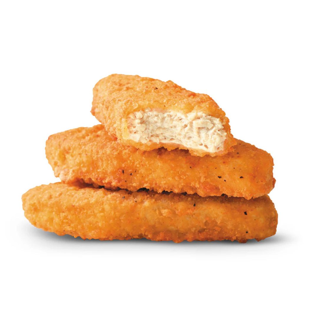 Three crispy plant-based nuggets stacked on white background, one with a bite showing texture