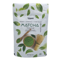 Ralph’s organic ceremonial matcha powder pouch with wooden spoon, bowl, tea whisk, and green leaves