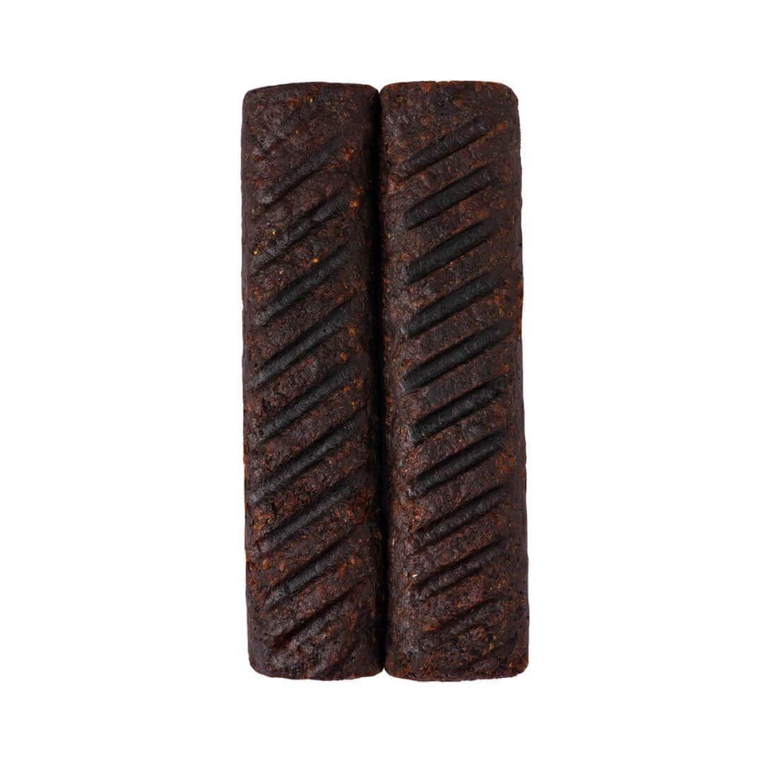 Two grilled plant-based kebab sausages with char marks on a white background from iPlantBased UAE.