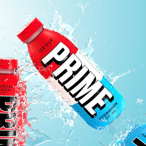 Red, white, and blue Prime hydration drink bottle with ice pop flavor, water splash background
