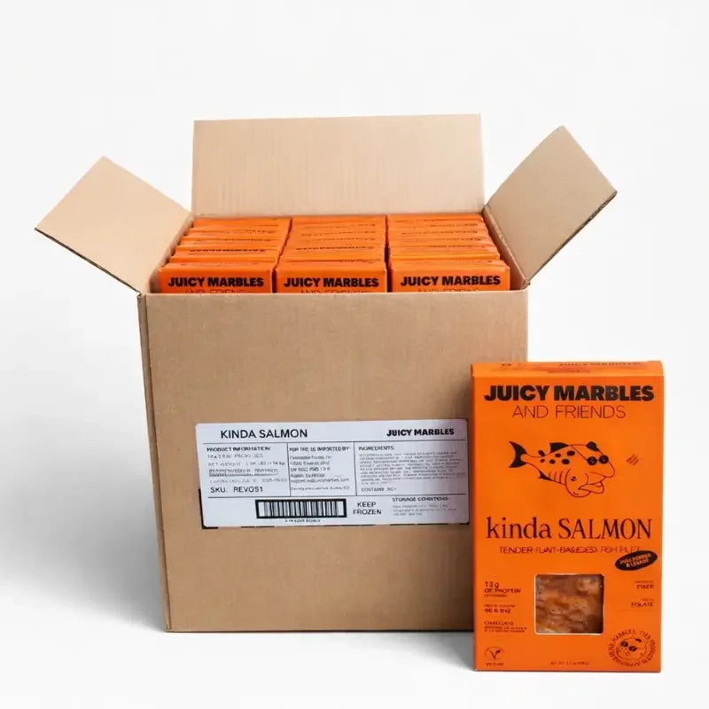 Open cardboard box with multiple boxes of 'Juicy Marbles and Friends' kinda Salmon on a white background.