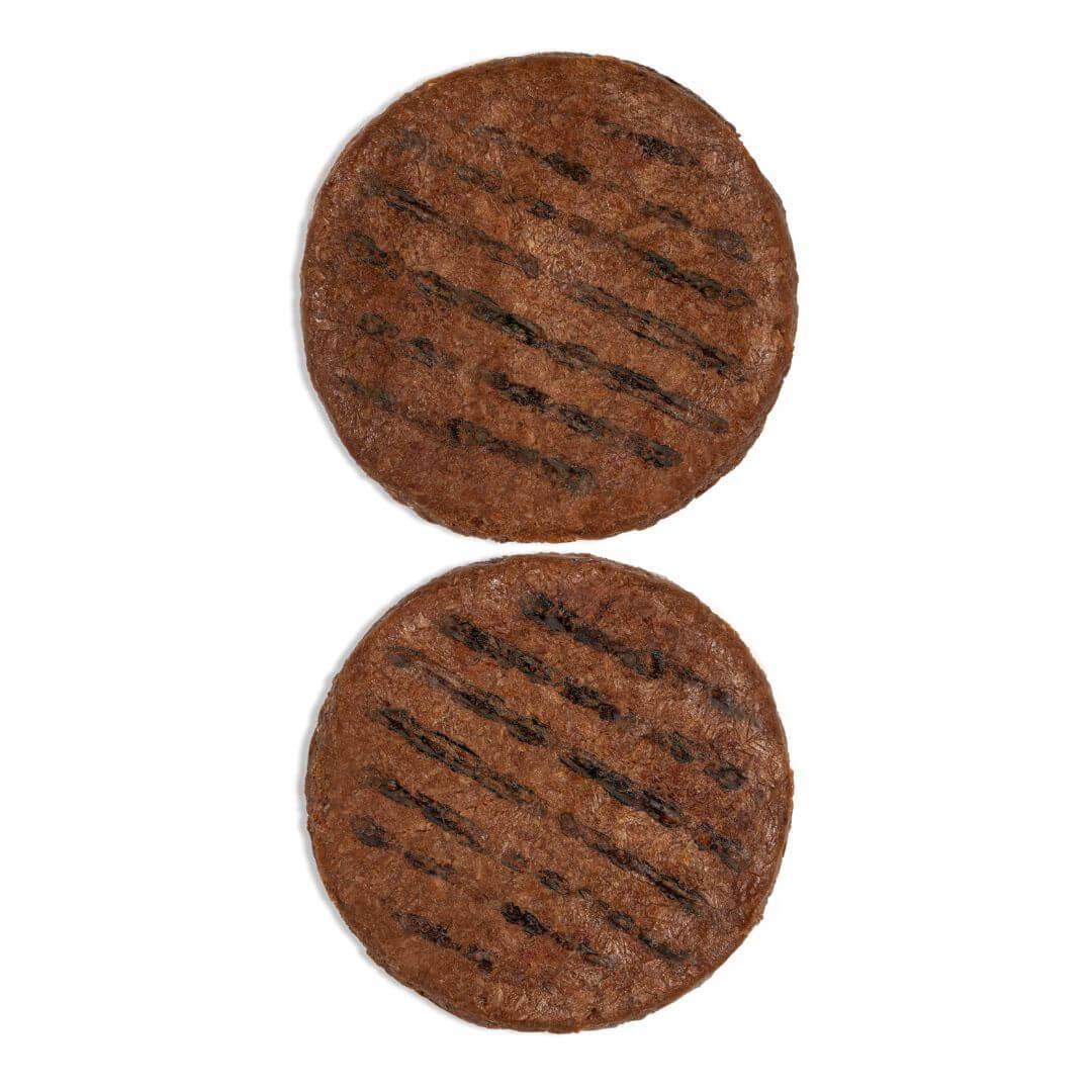 Two plant-based burger patties with grill marks on a white background from iPlantBased UAE.